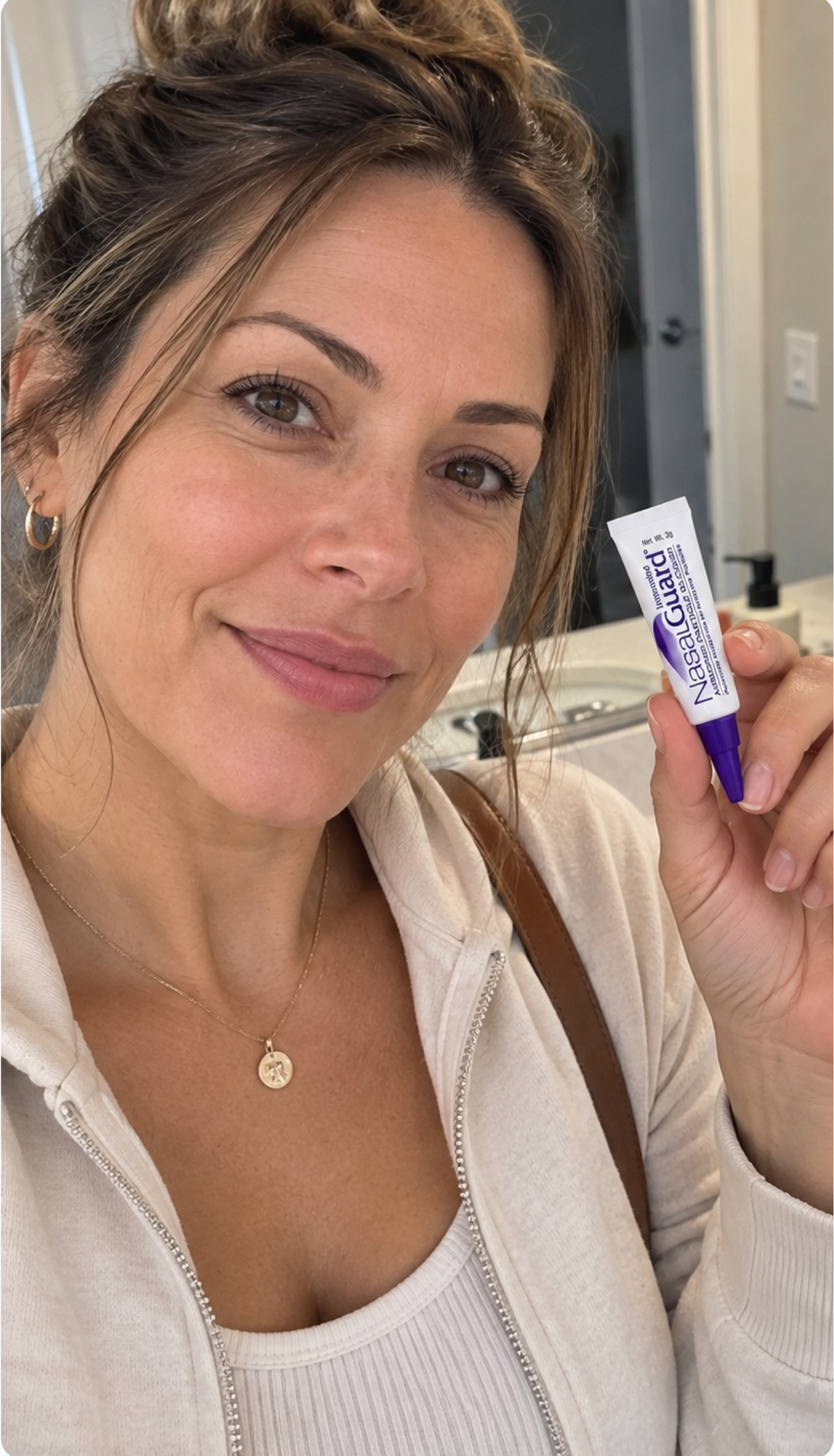 Woman applying NasalGuard Pollen & Dust Block
