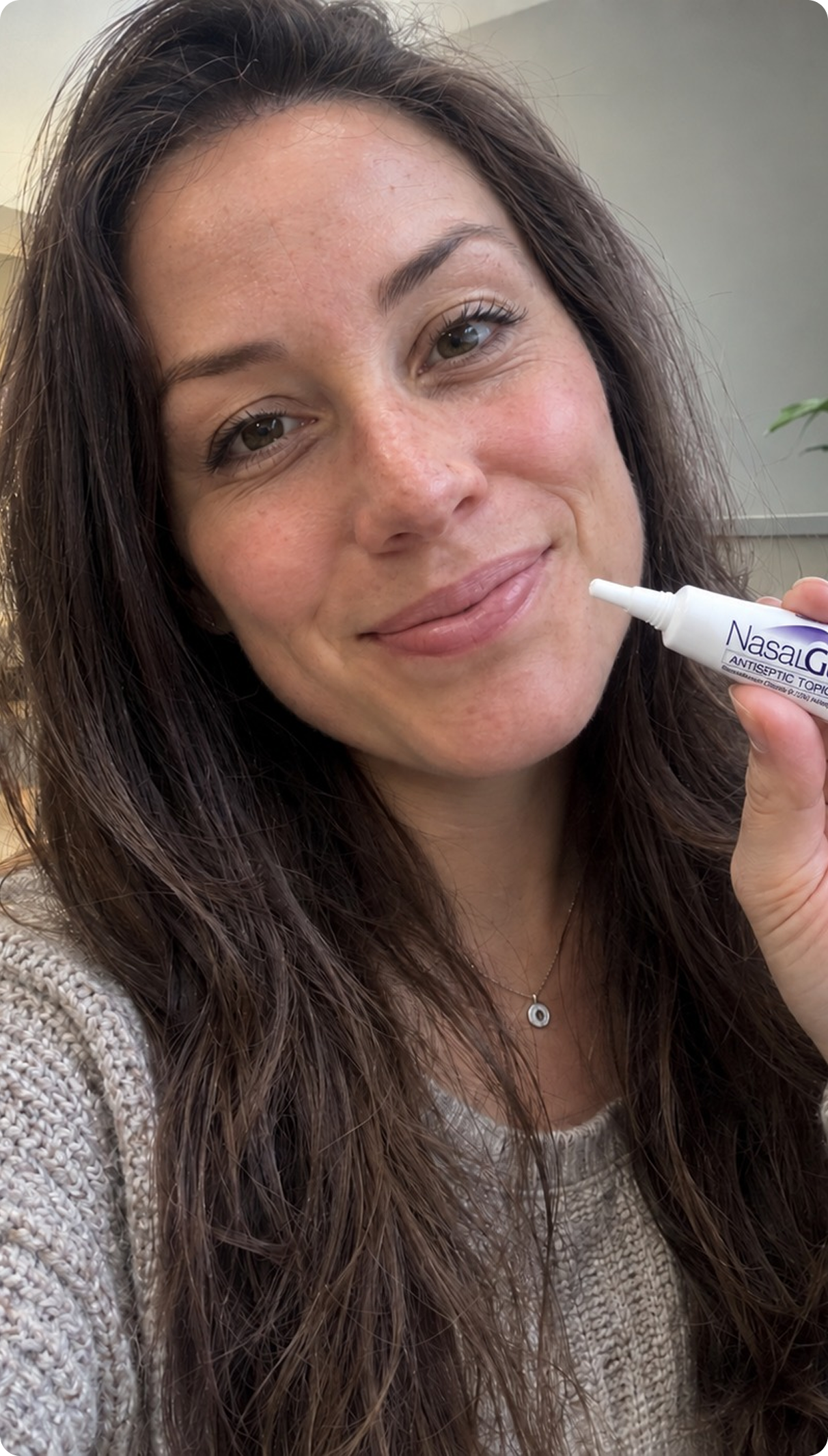 Woman applying NasalGuard Antiseptic Topical Gel