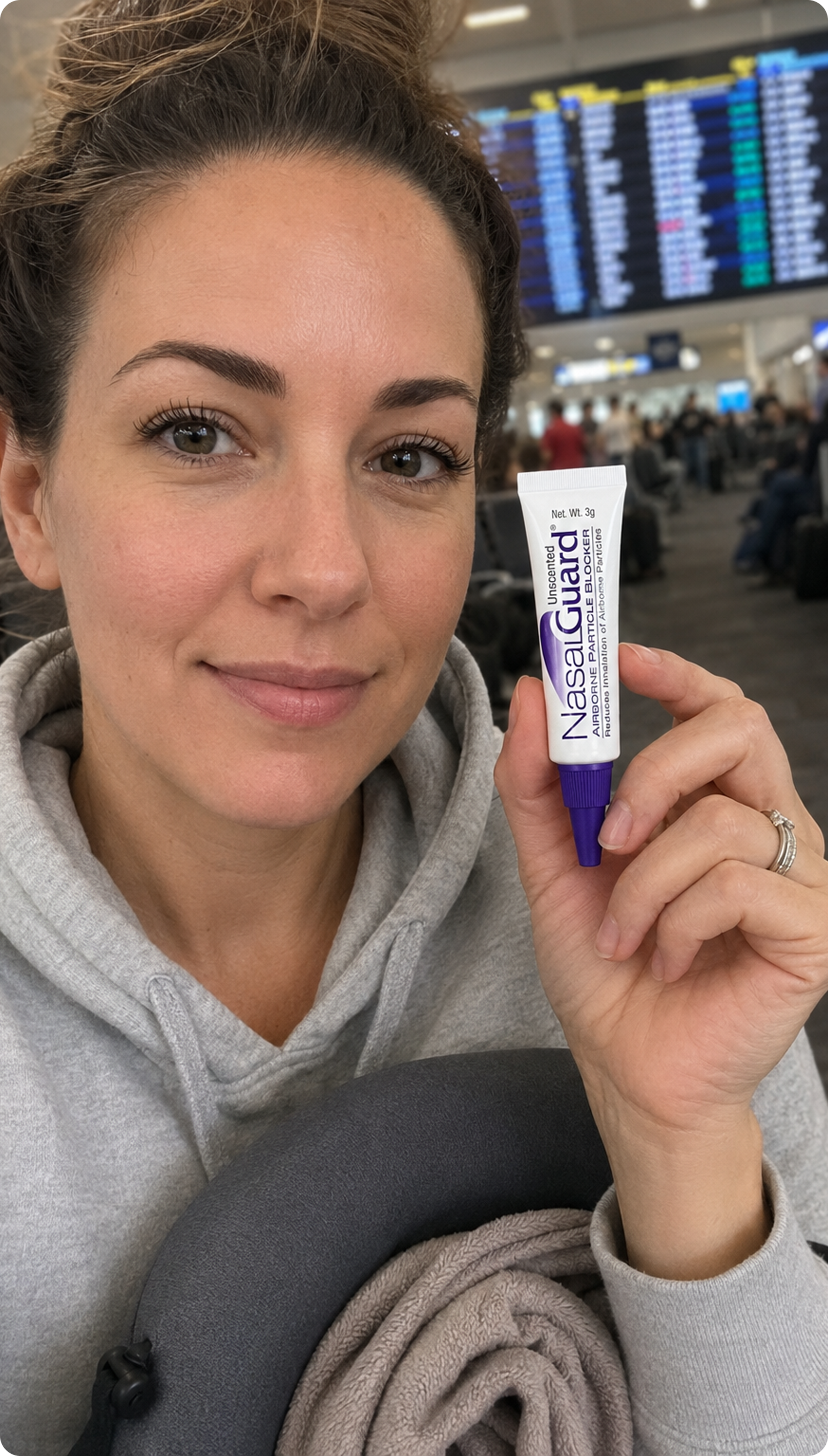 Air traveler holding NasalGuard at the airport gate