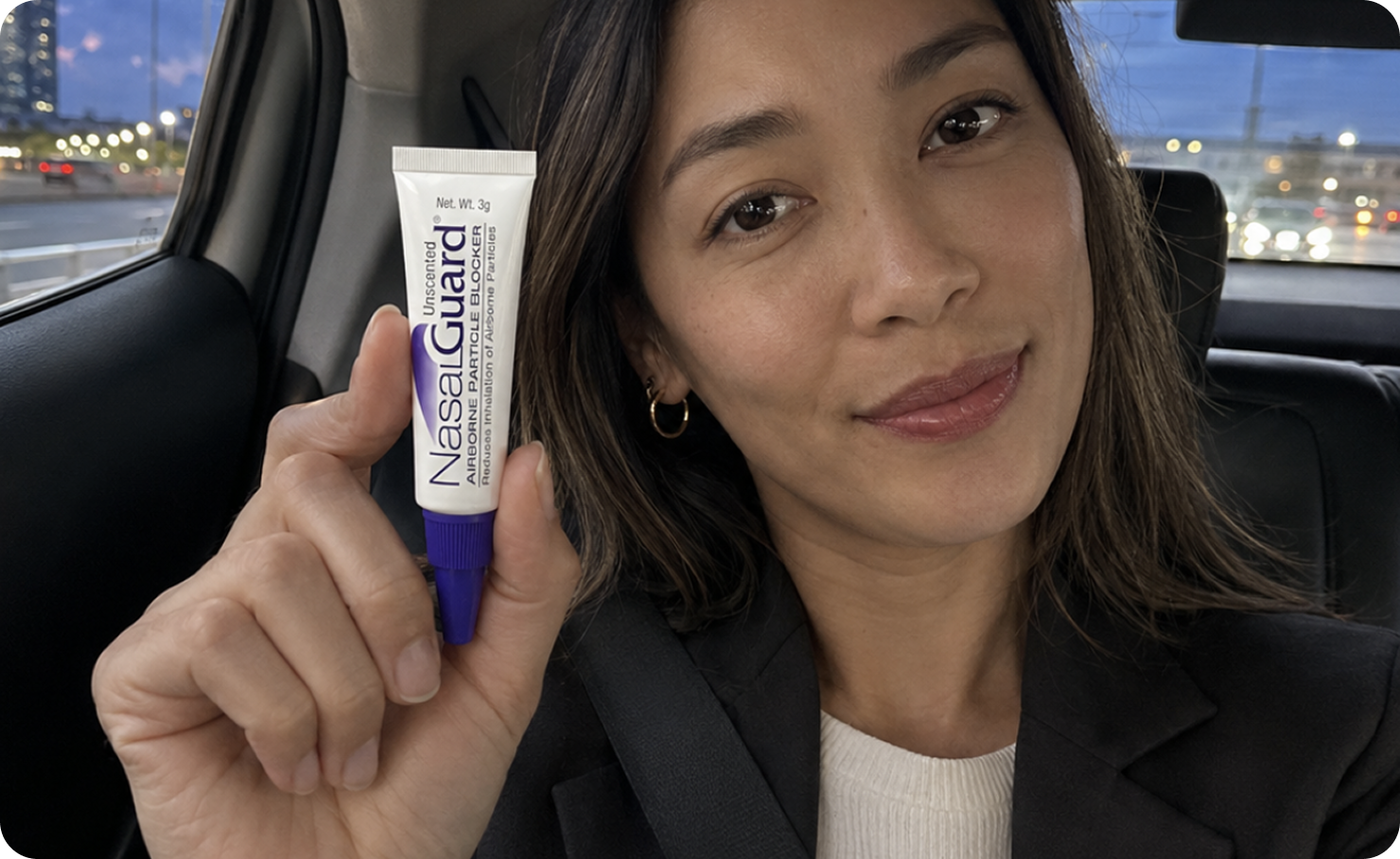 Traveler holding NasalGuard before a flight